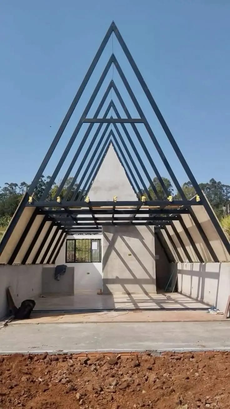 A-frame home with a concrete base and steel frame