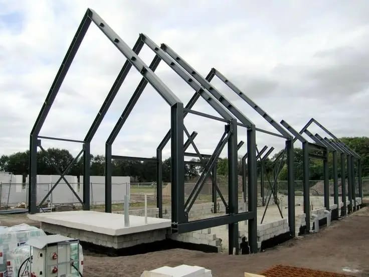 Row of steel gable frames on a construction site